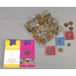 A quantity of British and world coins. Includes commemorative crowns, possible Roman examples, etc.