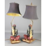 A pair of decorative composite Blackamoor figural table lamps. Height of figures 32cm.