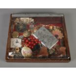 A small tabletop bijouterie case with contents of assorted costume jewellery and collectables. To