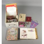 A box of assorted collectables and ephemera to include 1960's cruise dinner menus, world stamps,