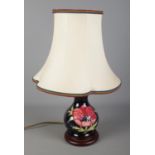A Moorcroft blue ground anemone pattern table lamp with shade. Approx. height without shade 20cm.