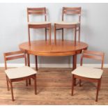 A teak extending dining table along with set of four upholstered chairs.
