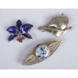 Three silver brooches. Includes enamelled floral example, Danish silver Viking boat, etc.