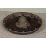 A vintage cast iron Mexican hat shaped trough. Diameter 90cm.