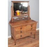 A carved oak dressing table with scrolling decoration. (160cm x 110cm)