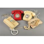 Four vintage telephones including two rotary dial examples.