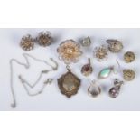 A quantity of silver and white metal. Includes white metal fob, pendants, filigree brooch and