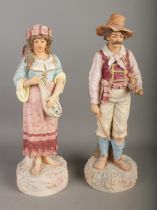 A pair of Robinson and Leadbeater ceramics figures formed as musicians, one with violin and one with