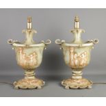 A large pair of Florence ceramic table lamps, formed as twin handled urns with figures to the front,
