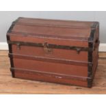 A vintage dome top wooden bound trunk.