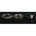 Three silver rings, one set with opal stone. Sizes JÂ½, O and PÂ½. Total weight: 5.3g