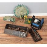 A box of decorative metal garden ornaments along with selection of hand tools. Includes chisels,