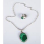 A silver and malachite pendant on chain along with a matching ring.