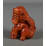 A Japanese carved Netsuke in the form of a elephant.