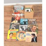 Two boxes of assorted vinyl records and singles of mainly pop and easy listening to include Elvis,