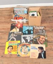 Two boxes of assorted vinyl records and singles of mainly pop and easy listening to include Elvis,