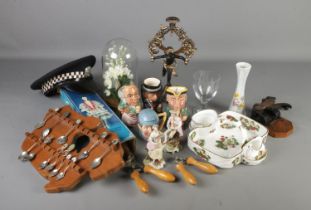 A box of mixed collectables including spoons on rack, glass dome, candlestick, Staffordshire