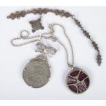 A silver St John Ambulance Association medal with attached silver date plaques along with a