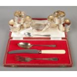 A collection of silver. Includes a set of six Walker & Hall napkin rings, cased three piece set,