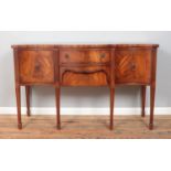 A Regency style mahogany serpentine front sideboard, with central drawers flanked by cupboard doors.