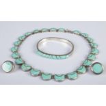 A silver and turquoise three piece jewellery suite. Includes necklace, bangle and earrings. 120g