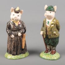 Two boxed Beswick ceramic figures titled Gentleman Pig and Lady Pig.