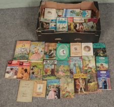 A box of vintage books. Includes Lady Bird books, Mills Boon examples, etc.