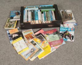 One box of cricket books, Olympics programs and sketching implements.