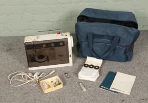 An Elna SU Air Electronic sewing machine with carry case, instruction manual and small collection of