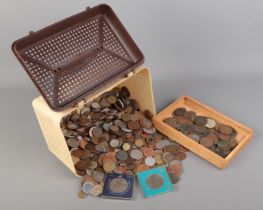 A box of British pre decimal and world coins. Includes cased commemorative crowns, Victorian pennies