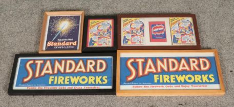 A collection of vintage framed Standard firework advertisements with one featuring Bangers by