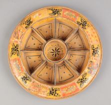 A wooden Pope Joan staking board with painted and applied decoration. Diameter 29cm.