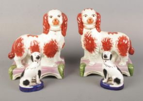 Two pairs of Staffordshire ceramic mantel dogs including standing pair mounted on pink base