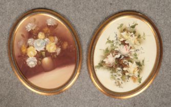 A pair of oval oil paintings, canvas laid on wooden panel, still life of flowers with gilt frame.