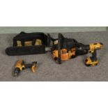 A Mac 335 petrol powered chain saw along with two Dewalt cordless drills (one missing battery) in