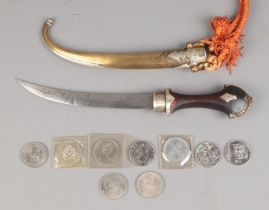 A Morroccan Jimbaya dagger featuring brass and white metal scabbard along with small quantity of