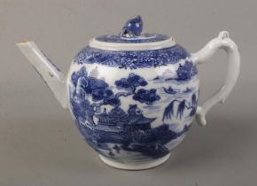 A 19th century bullet shape teapot with blue and white transfer print and lotus flower bud finial.