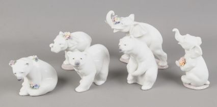 A collection of Lladro including three Lladro polar bears and three elephants. Larger elephant