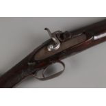 A late 19th century percussion cap rifle. Having 82cm cylindrical barrel and chequered walnut stock.