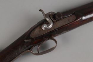 A late 19th century percussion cap rifle. Having 82cm cylindrical barrel and chequered walnut stock.