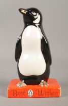 A Royal Doulton for Penguin books figure modelled as penguin standing upon a book titled 'Best