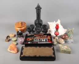 An assortment of collectables, to include cribbage board, shells, scent bottles and miniature oil