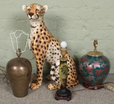 Three tables lamps and a large ceramic cheetah. Table lamps include hammered metal and floral