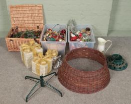 Three boxes of Christmas decorations. Includes baubles, cast iron tree stand, graduated light up