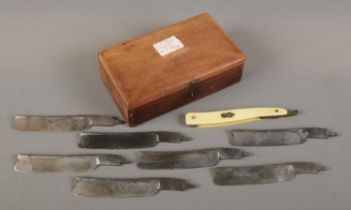 A wooden cased cut throat razor set consisting of ivorine handle and seven John Ledger blades. Lid