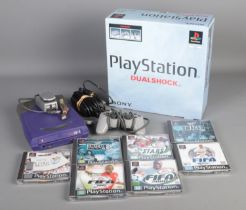A boxed Sony Playstation Dualshock along with six boxed games to include Fifa 2000, Smackdown, The