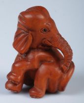 A Japanese carved Netsuke in the form of a elephant.