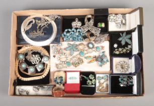 A tray containing an assortment of vintage costume jewellery, including enamel cufflinks, peacock