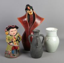 Four unusual pieces of mainly ceramics, to include musical Toby jug, modernist bust and locally