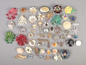 A good collection of over fifty costume jewellery brooches, including floral, animal, snowflake